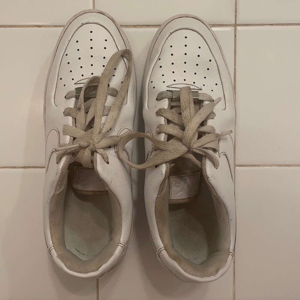 Worn, white Nike Air Force 1 low casual shoe